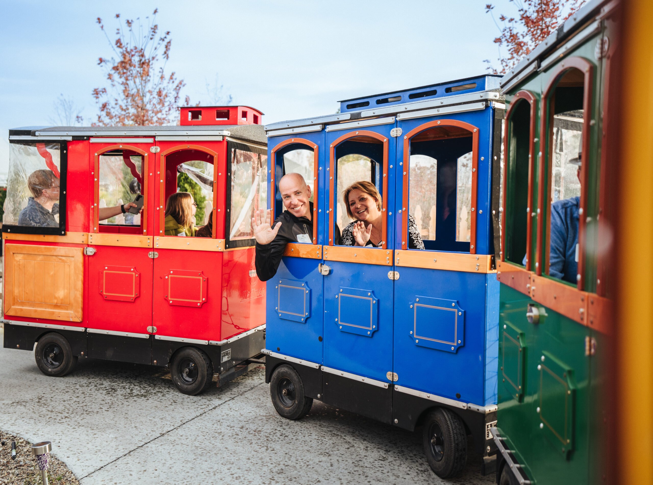 President Joe Bielawski and Chief Executive Officer Julie Bielawski riding in a train at Knowledge Services' Fall Fest.