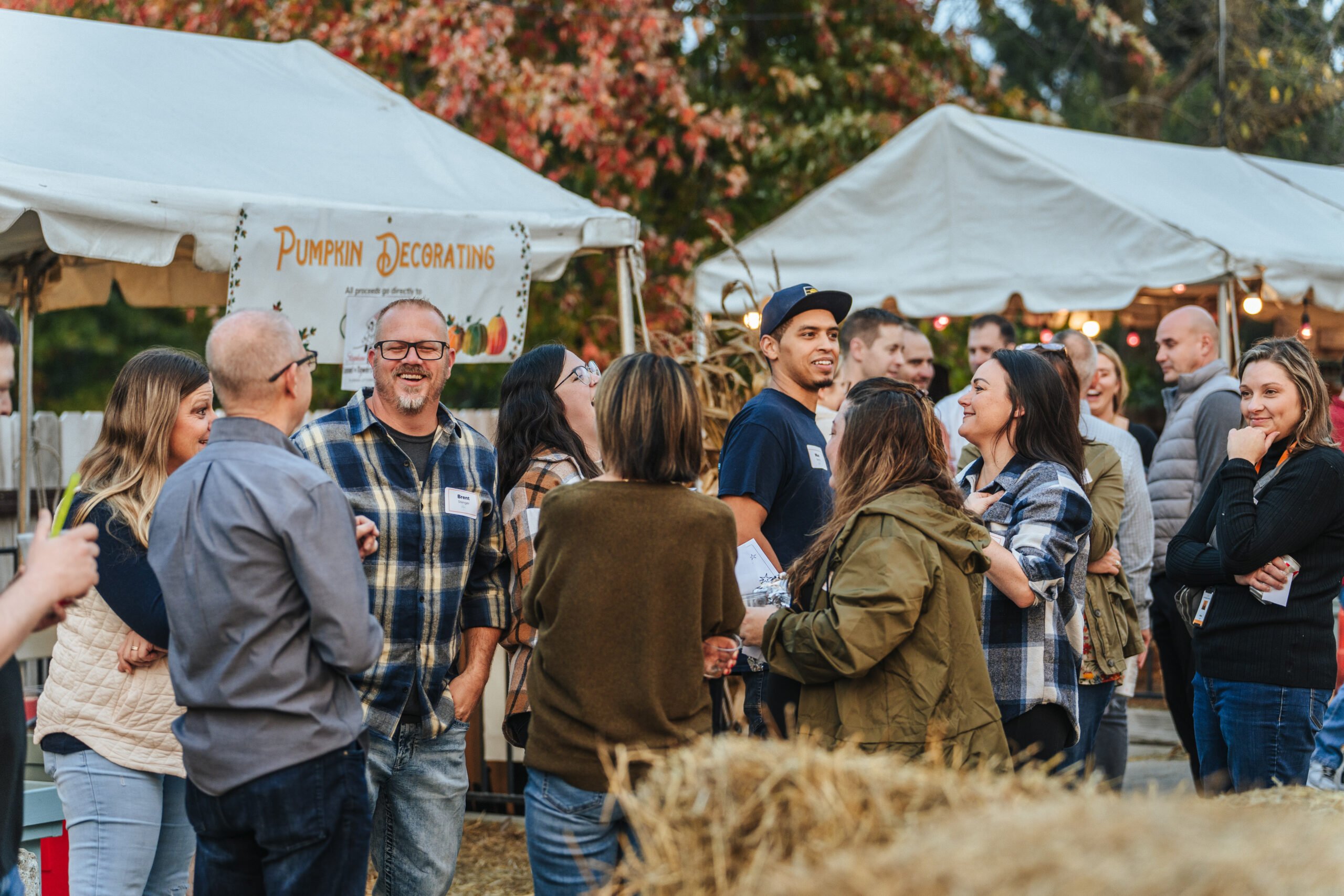 Knowledge Services' employees celebrate outdoors at the first Fall Fest at Allisonville Home and Garden by Sullivan.