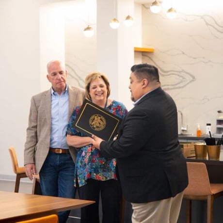 Photo of Knowledge Services President, Joe Bielawski, and CEO, Julie Bielawski, accepting the Friends of West Point induction from a United States Military Academy member.