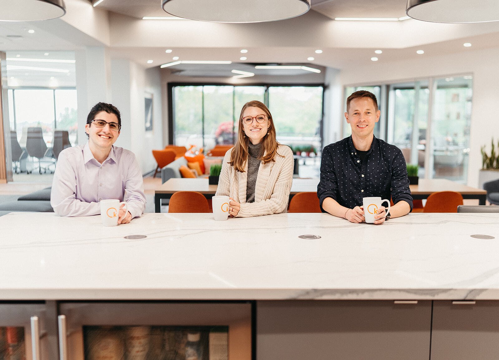 Team members posing at table