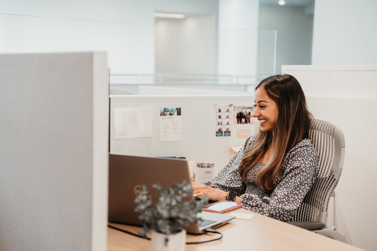 Image of smiling woman at desk
