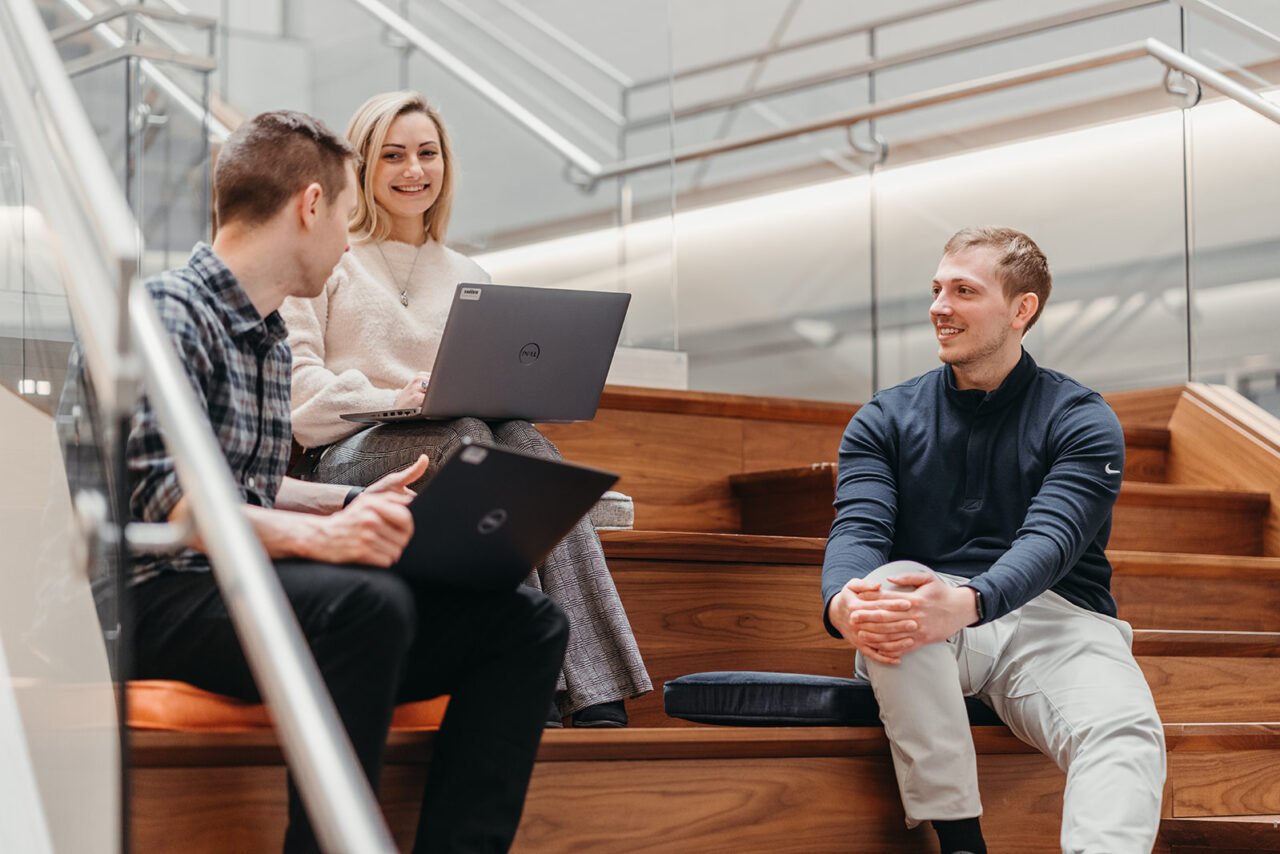 Image of three team members working on stairs