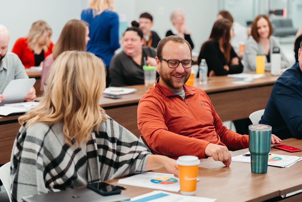 Image of man and woman laughing at corporate event