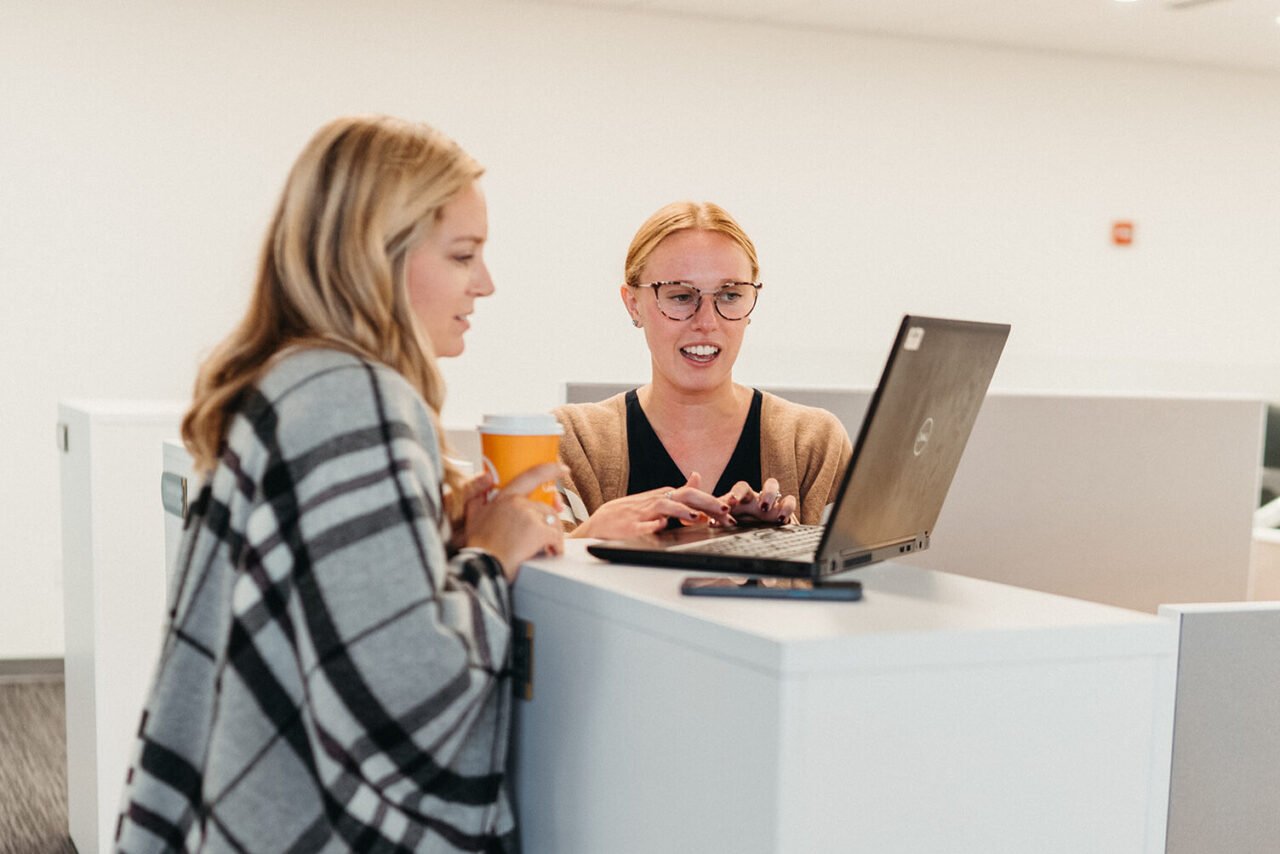 Image of two women working on a laptop