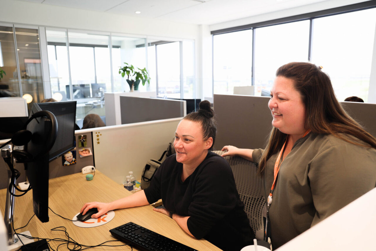 Image of two smiling women working on computer