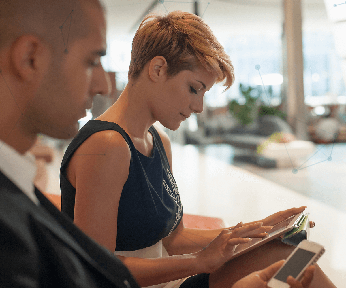 Image of woman looking at her tablet and working