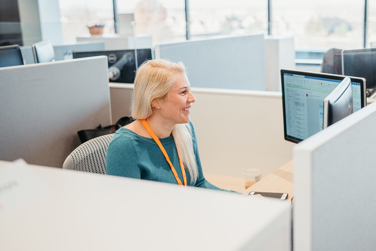 image of man sitting at a desk smiling