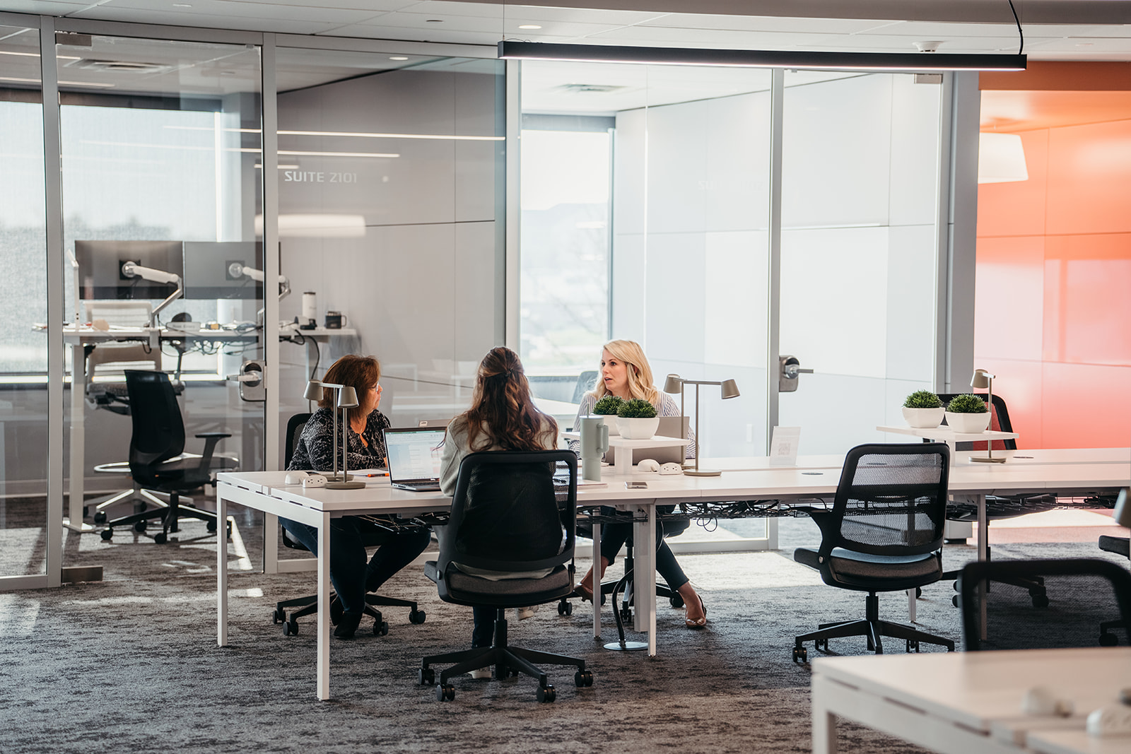 Image of two people working at a table and discussing