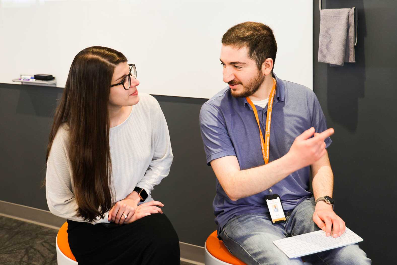 Image of woman lecturing a group of people at a conference table