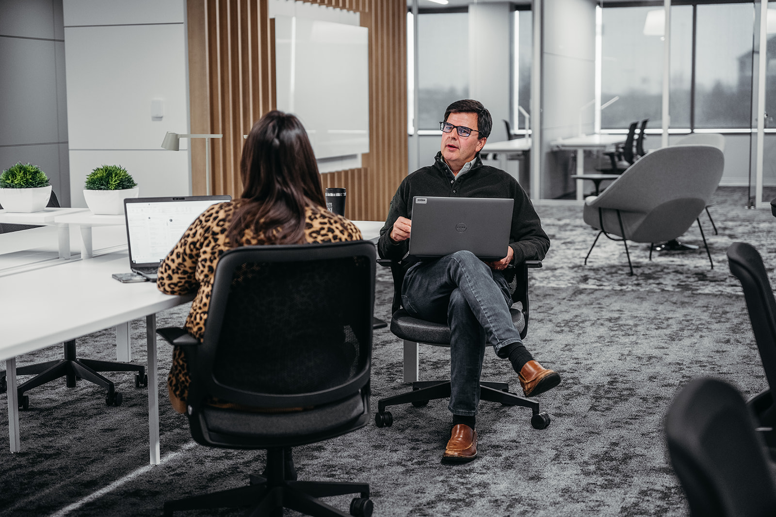 Image of two people working at a table and discussing