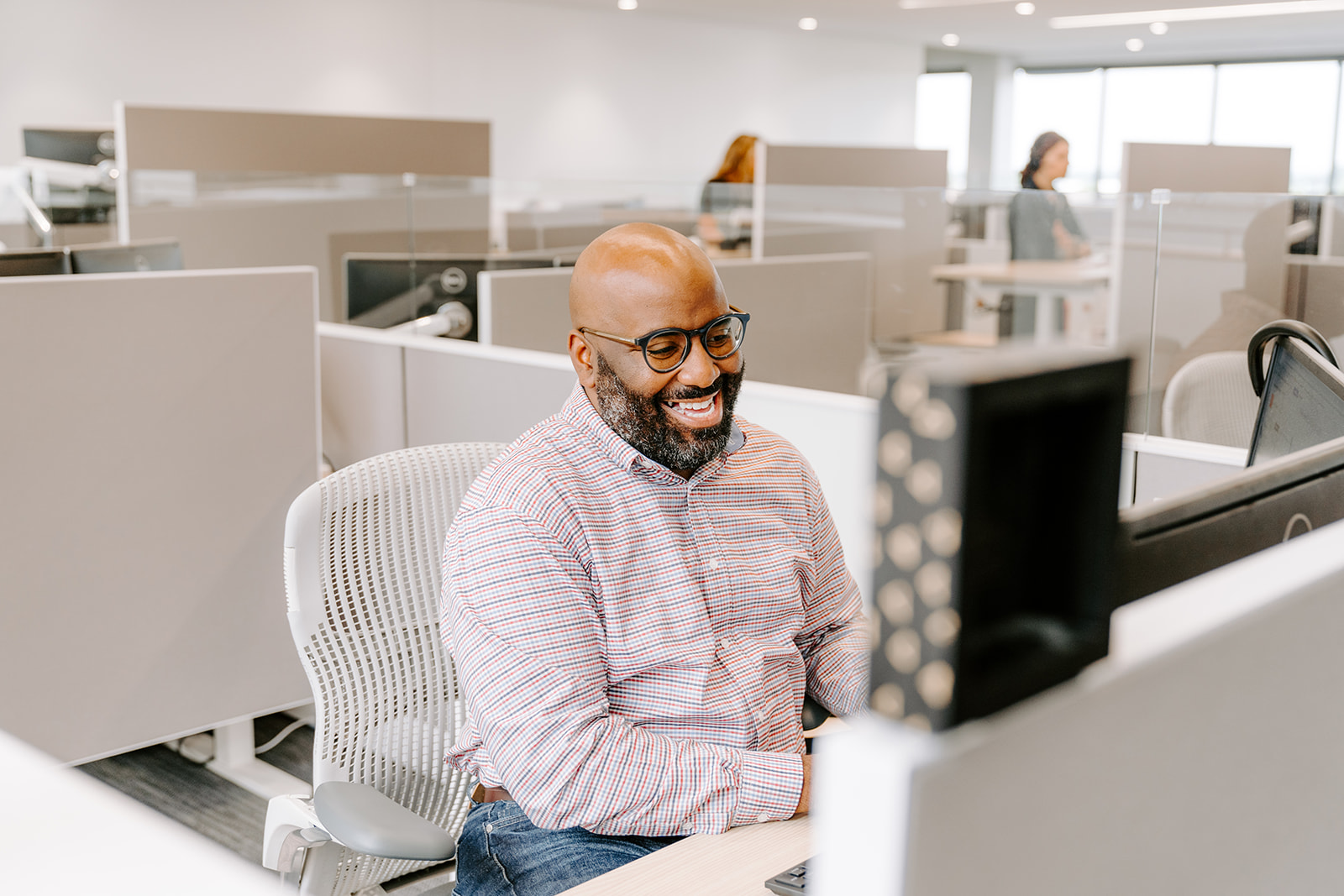 image of man sitting at a desk smiling