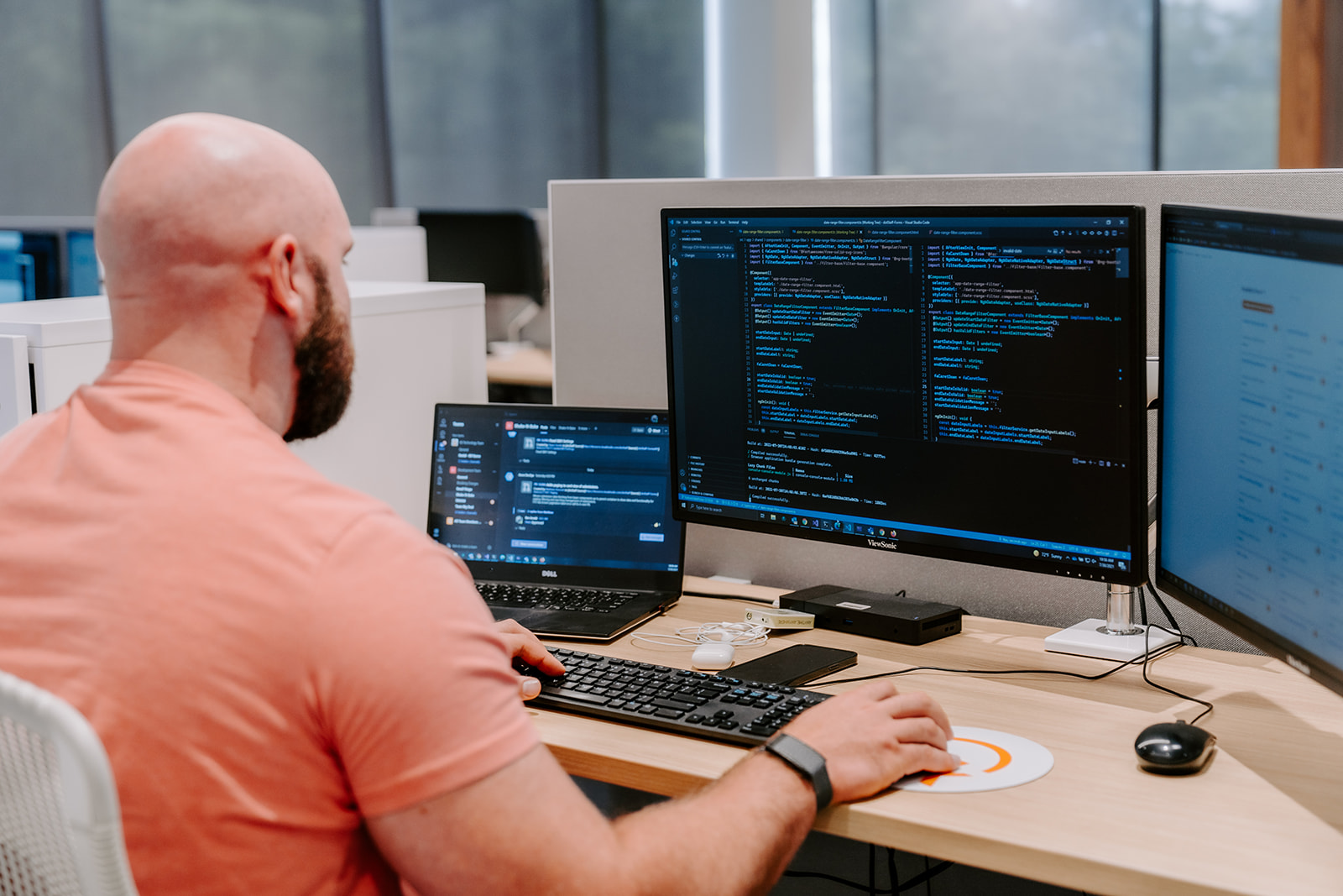 image of man sitting at a desk smiling