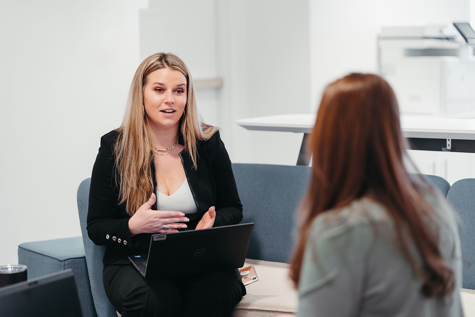 Image of two people working at a table and discussing