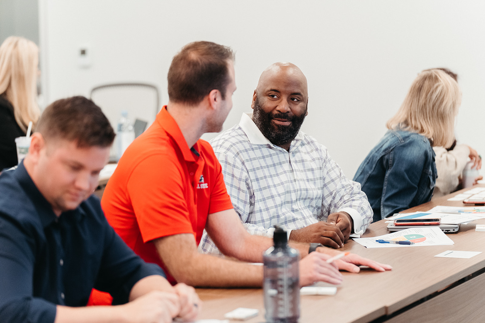 Image of woman lecturing a group of people at a conference table