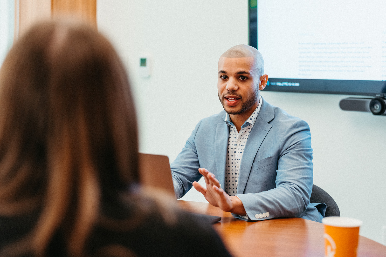 Image of two people working at a table and discussing