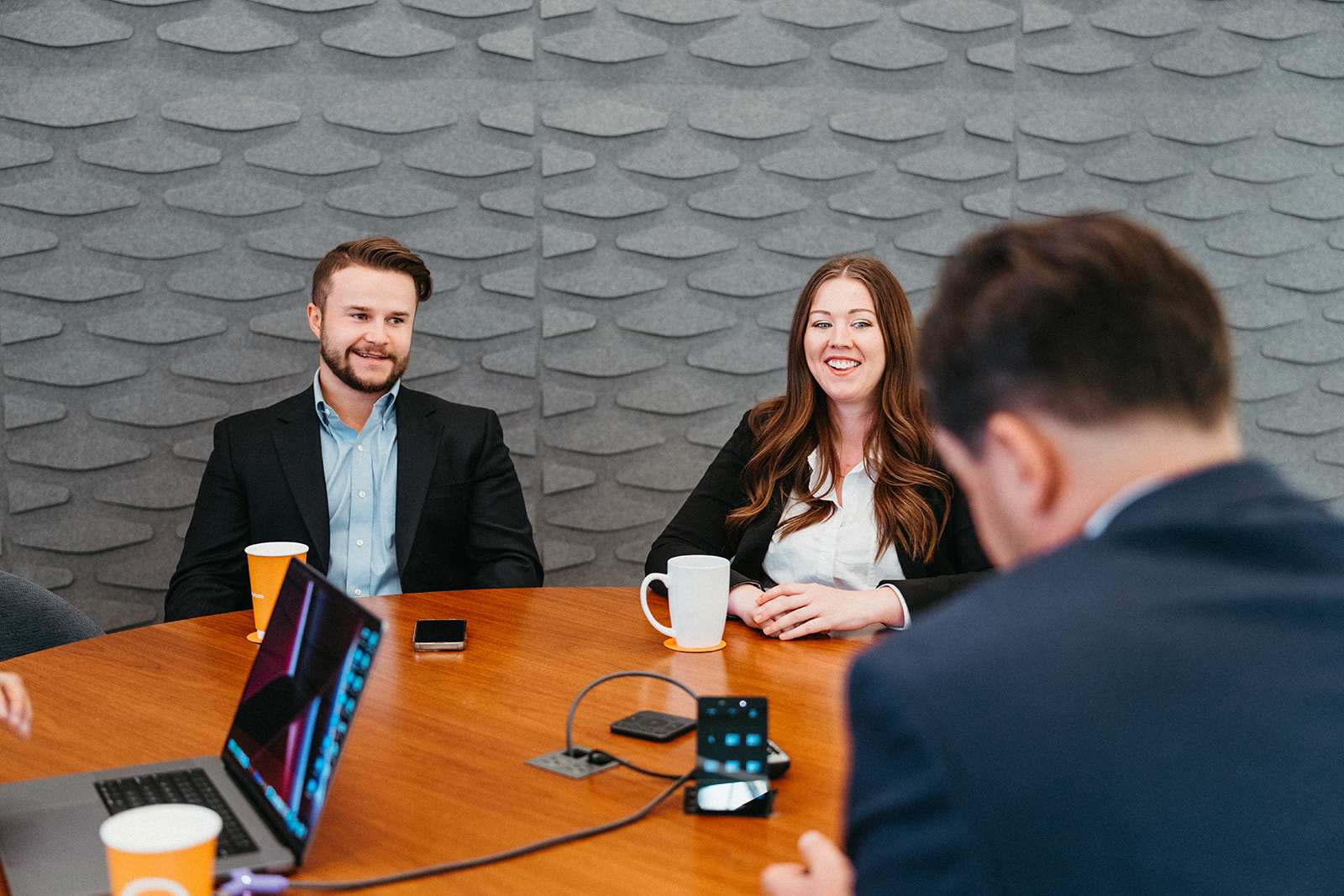 image of man sitting at a desk smiling