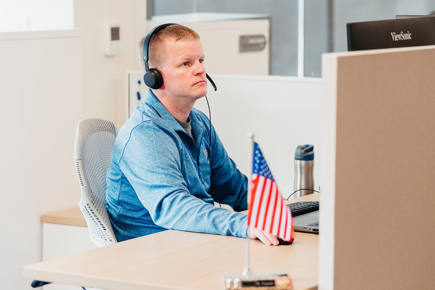 image of man sitting at a desk smiling