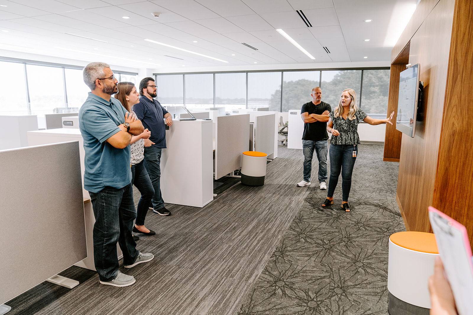 Image of woman lecturing a group of people at a conference table